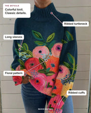 Alice sweater showing its ribbed turtleneck, long sleeves, colorful floral pattern and ribbed cuffs.