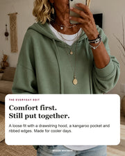 Amandine sweater editorial card: drawstring hood, kangaroo pocket, ribbed hem.