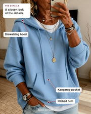 Ines sweater details: drawstring hood, kangaroo pocket, ribbed hem.