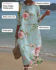 Keely dress showing its round neckline, belly-cover cut, half sleeves and floral print.