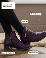 Melinda ankle boot showing its ruched upper, side zip, low stacked heel and rounded toe.