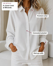Mirande blouse details: pointed collar, concealed placket, roll-up cuffs.