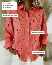 Priscilla blouse details: wave-and-dot print, button-up front, buttoned cuffs.