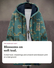 Sadie hoodie editorial card: A lined hood, drawstrings and a branch-and-blossom print on a teal ground.